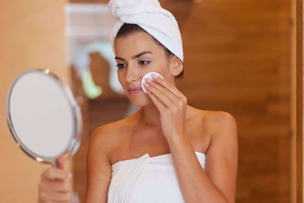 woman-cleaning-face-in-bathroom